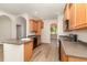 Charming kitchen with wood cabinets, island, and modern appliances at 3036 Landing Falls Ln, Raleigh, NC 27616