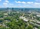 Aerial view of city skyline and neighborhoods with mature trees at 304 Polk St, Raleigh, NC 27604
