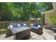 The back deck has seating, a firepit table, and lots of greenery adding privacy at 304 Polk St, Raleigh, NC 27604