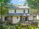 Back exterior featuring a wooden deck, brick accents, and a well-maintained lawn at 304 Polk St, Raleigh, NC 27604