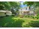 Expansive backyard featuring a large deck, lush lawn and beautiful landscaping for outdoor enjoyment at 304 Polk St, Raleigh, NC 27604