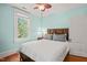 This bedroom has hardwood floors, a ceiling fan, light blue walls and one window with white trim at 304 Polk St, Raleigh, NC 27604
