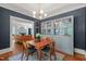 Dining room featuring glass display cabinets, hardwood floors, and view to living room at 304 Polk St, Raleigh, NC 27604