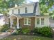 View of home's side and front with brickwork, gabled roof and many windows at 304 Polk St, Raleigh, NC 27604