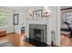 Stone fireplace with white mantel in living room with hardwood floors at 304 Polk St, Raleigh, NC 27604