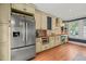 Bright kitchen with stainless steel refrigerator, plenty of cabinets, and hardwood floors at 304 Polk St, Raleigh, NC 27604