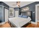 This spacious main bedroom has a ceiling fan, nice-sized windows, and blue walls with white trim at 304 Polk St, Raleigh, NC 27604