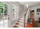Open staircase with hardwood steps and white risers leads to the second floor with lots of natural light at 304 Polk St, Raleigh, NC 27604