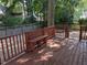 Backyard wood deck with a bench overlooking a pebble-covered patio at 3109 Benton Cir, Raleigh, NC 27615