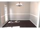 Dining room featuring neutral paint, hardwood floors, and a modern chandelier at 3109 Benton Cir, Raleigh, NC 27615