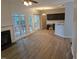 Bright, open concept living room with hardwood floors, a fireplace, and access to the outdoor deck at 3109 Benton Cir, Raleigh, NC 27615