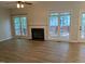 Spacious living area with hardwood floors, a fireplace, and large windows at 3109 Benton Cir, Raleigh, NC 27615