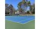 Close-up of a vibrant blue and green community tennis court with nets and clear markings at 3109 Benton Cir, Raleigh, NC 27615