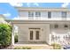 Rear exterior view of a white townhouse featuring a patio, double doors, and a manicured lawn at 3147 Rapid Falls Rd, Cary, NC 27519