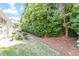 Backyard space featuring green grass, an AC unit, and lush landscaping for privacy and shade at 3147 Rapid Falls Rd, Cary, NC 27519