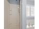 Bright white shower stall next to a soaking tub with a shuttered window at 3147 Rapid Falls Rd, Cary, NC 27519
