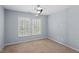 Neutral bedroom with two shuttered windows and modern ceiling fan with light at 3147 Rapid Falls Rd, Cary, NC 27519