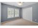Bedroom with two windows and carpet floors at 3147 Rapid Falls Rd, Cary, NC 27519