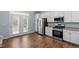 Kitchen showcasing stainless steel appliances and hardwood floors at 3147 Rapid Falls Rd, Cary, NC 27519