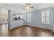Open living room with hardwood floors, plantation shutters, and easy access to the kitchen at 3147 Rapid Falls Rd, Cary, NC 27519