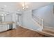 Open living room with wood floors, stairs, and white trim at 3147 Rapid Falls Rd, Cary, NC 27519