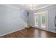 Open living room with wood floors and access to the backyard at 3147 Rapid Falls Rd, Cary, NC 27519
