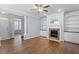 Spacious living room featuring a fireplace, built-in shelving, and hardwood floors at 3147 Rapid Falls Rd, Cary, NC 27519