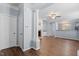 Open-concept living room features hardwood floors, a fireplace, and an open view of the kitchen at 3147 Rapid Falls Rd, Cary, NC 27519
