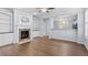 Living room with fireplace, built-in shelves, and hardwood floors, providing a cozy and stylish space at 3147 Rapid Falls Rd, Cary, NC 27519