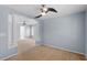 Open living room space featuring columns, neutral carpet and a modern ceiling fan at 3147 Rapid Falls Rd, Cary, NC 27519