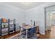 Well-lit office space features a bookcase, a modern desk, and access to other rooms at 3147 Rapid Falls Rd, Cary, NC 27519