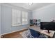 Bright office features plantation shutters, hardwood floors, and a modern desk setup at 3147 Rapid Falls Rd, Cary, NC 27519