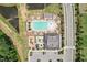 Overhead shot showcases the community pool, playground, and clubhouse, surrounded by well-maintained landscaping and amenities at 3194 Retama Run, New Hill, NC 27562