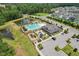 Aerial view of the community clubhouse, pool, and playground facilities, offering a resort-style living experience for residents at 3194 Retama Run, New Hill, NC 27562