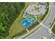 Aerial view of community tennis and basketball courts near the playground and parking at 3194 Retama Run, New Hill, NC 27562