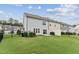 This backyard features a fence, grass and leads into the townhome with a sliding glass door at 3194 Retama Run, New Hill, NC 27562
