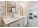 Bathroom with white vanity, dual sinks, quartz counters, and a view to the bedroom at 3194 Retama Run, New Hill, NC 27562