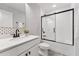 This bathroom features stylish wallpaper and a shower over bath at 3194 Retama Run, New Hill, NC 27562