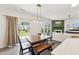 Dining area with an exterior view next to a modern living room with a fireplace at 3194 Retama Run, New Hill, NC 27562