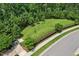 A fenced dog park with green space and mature trees for shade, perfect for pets to run and play in a secure environment at 3194 Retama Run, New Hill, NC 27562