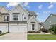 Charming two-story townhome with attached two-car garage and beautifully landscaped front yard at 3194 Retama Run, New Hill, NC 27562