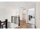 Upstairs hallway with wood floors and access to the laundry room at 3194 Retama Run, New Hill, NC 27562