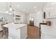 Bright, modern kitchen features white cabinetry, stainless steel appliances, and quartz countertops at 3194 Retama Run, New Hill, NC 27562