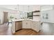 Kitchen island featuring modern stainless steel dishwasher, sink and beautiful white cabinetry at 3194 Retama Run, New Hill, NC 27562