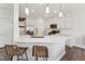 Modern kitchen with white cabinetry, stainless steel appliances, and a large island with seating at 3194 Retama Run, New Hill, NC 27562