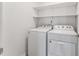 This laundry room includes a white washer and dryer and white shelves at 3194 Retama Run, New Hill, NC 27562
