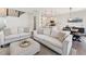 Spacious living room that flows into a kitchen and dining area, with hardwood flooring and modern finishes at 3194 Retama Run, New Hill, NC 27562