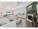 Open-concept living room with a fireplace, comfortable seating, and seamless flow into dining and kitchen at 3194 Retama Run, New Hill, NC 27562