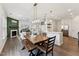 Bright open concept living room, dining and kitchen area with modern design at 3194 Retama Run, New Hill, NC 27562