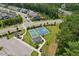 Aerial view highlighting basketball and tennis courts, a covered gazebo, and manicured grounds perfect for outdoor activities at 3194 Retama Run, New Hill, NC 27562